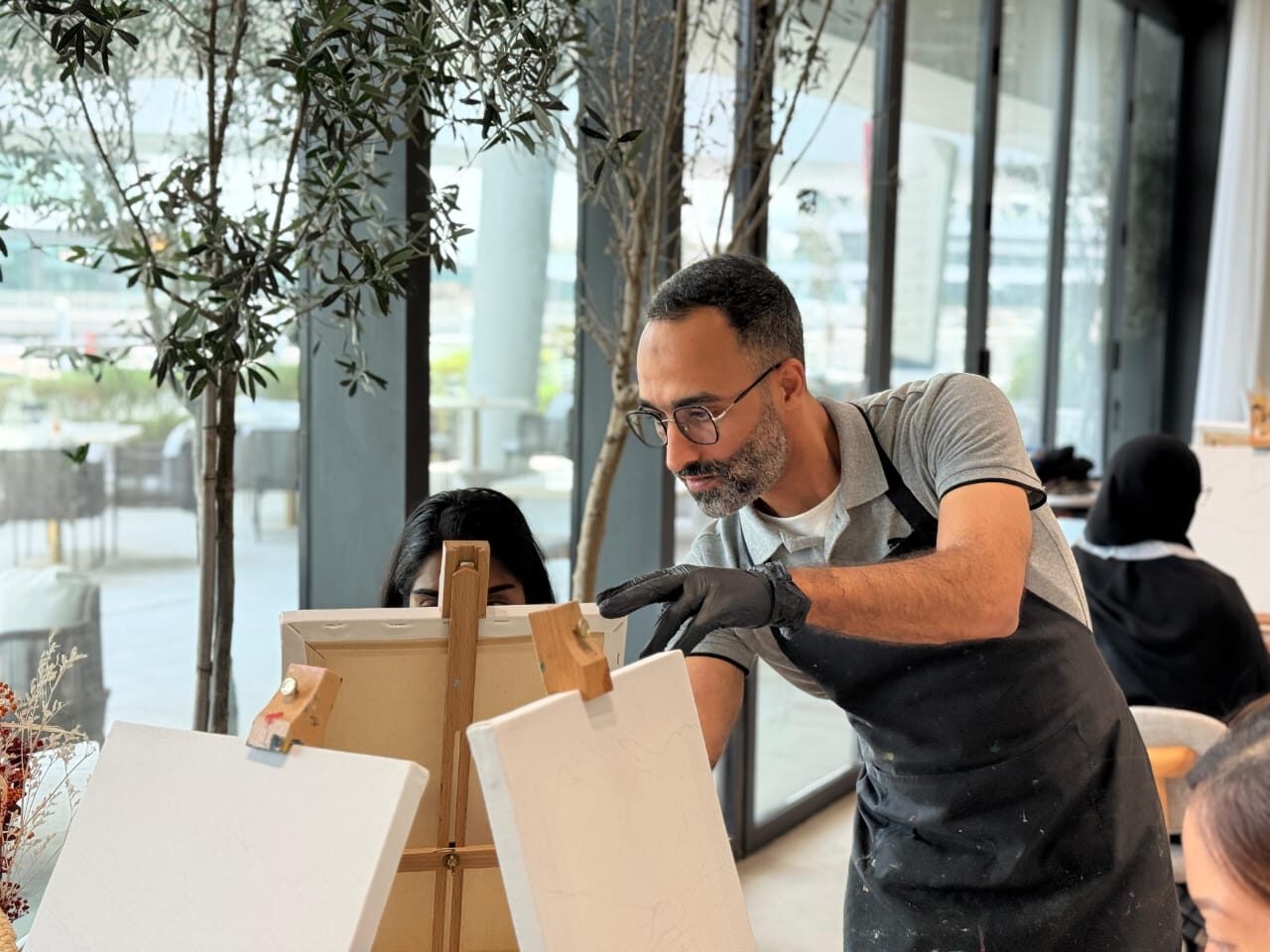 Abdelrahman Abdelmoneim leading a painting workshop